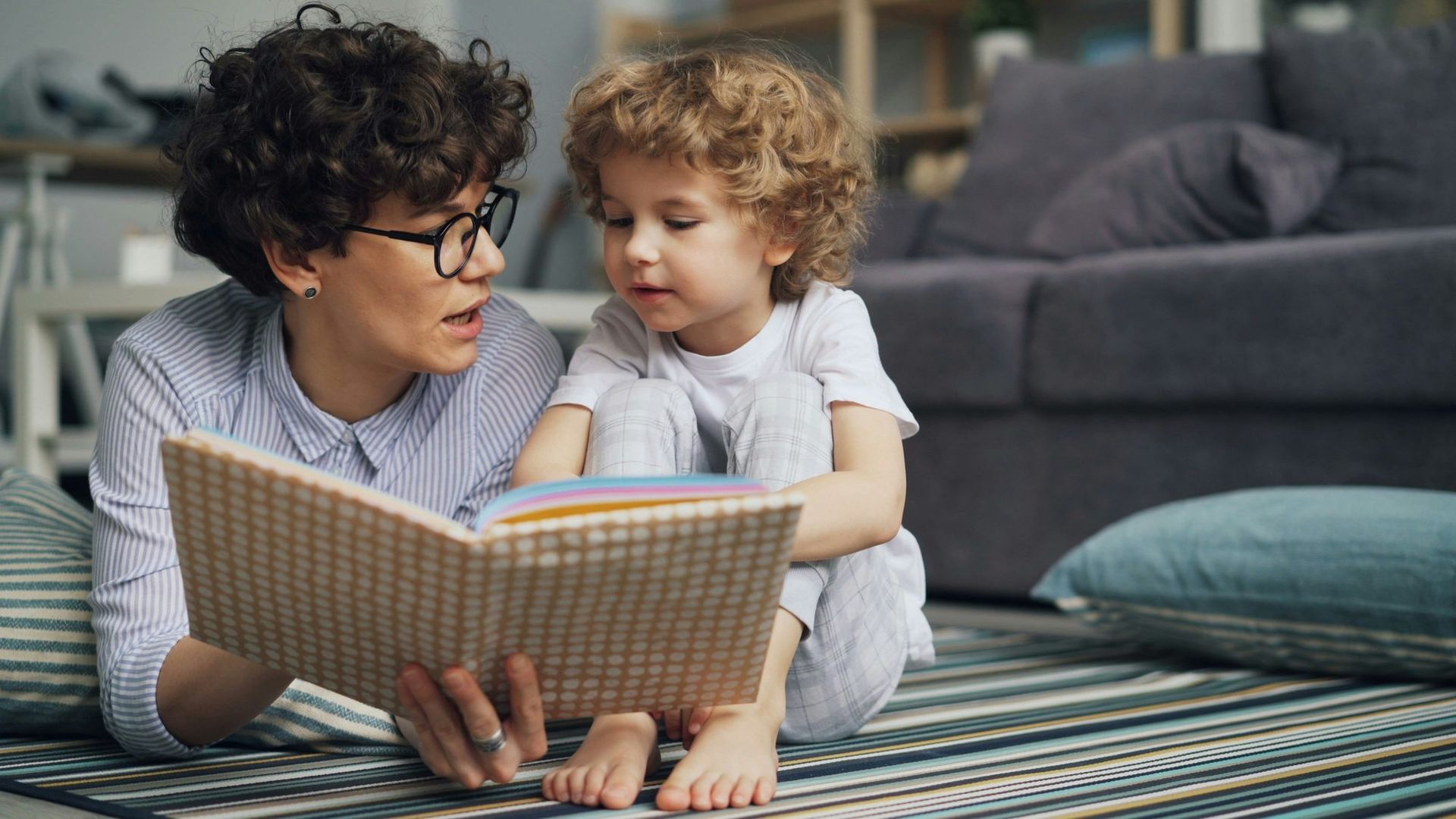 A mother and son reading together